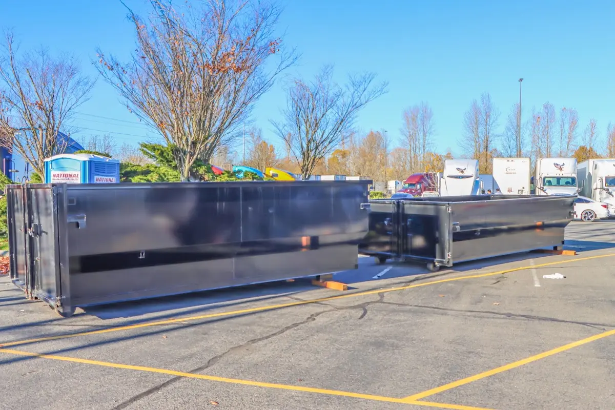 Professional dumpster rental service with roll-off container on residential driveway in Hernando